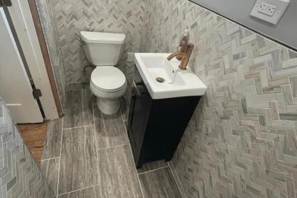 Herringbone tile bathroom remodel by CorContracting in Spotswood, NJ