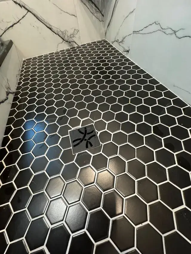 Black hexagon tile shower floor installed by CorContracting in North Brunswick, NJ