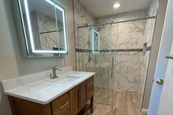 Bathroom remodel with modern vanity and glass shower enclosure by CorContracting in South Brunswick, NJ