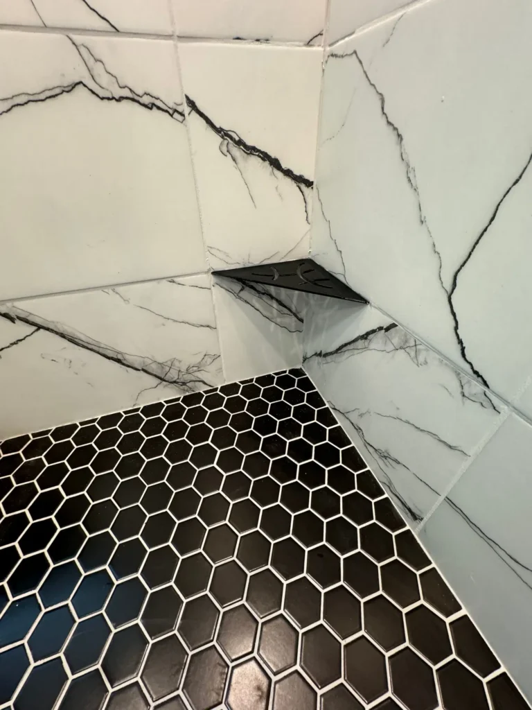 Black hexagon tile shower corner shelf by CorContracting in New Brunswick, NJ