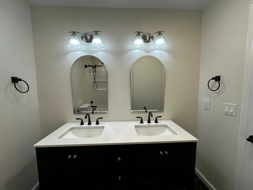 Dual sink bathroom vanity remodel with arched mirrors in Piscataway, NJ