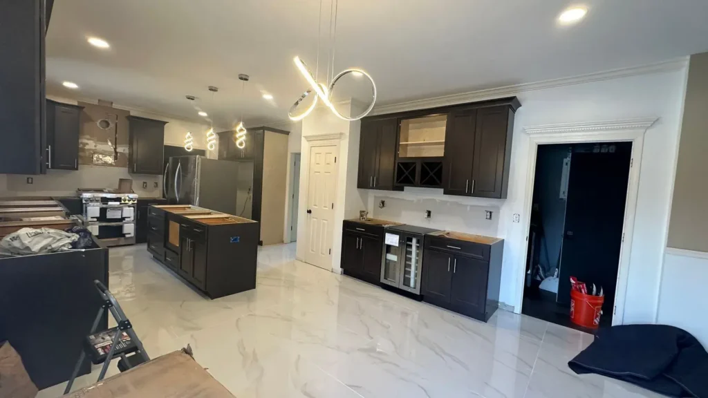 Kitchen remodel with dark cabinets and island by CorContracting in East Brunswick, NJ