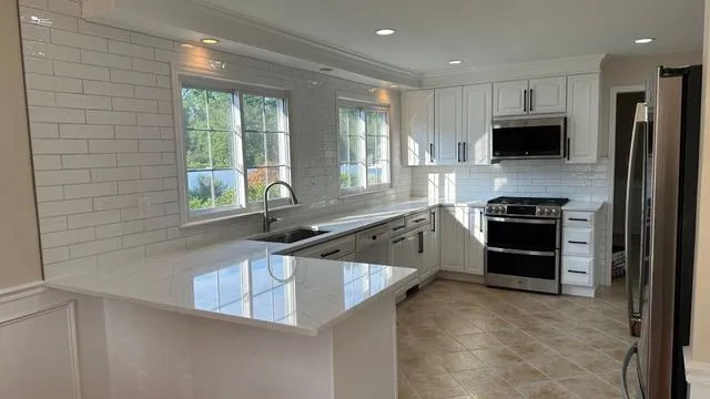 Modern kitchen remodel with white cabinets by CorContracting in Edison, NJ