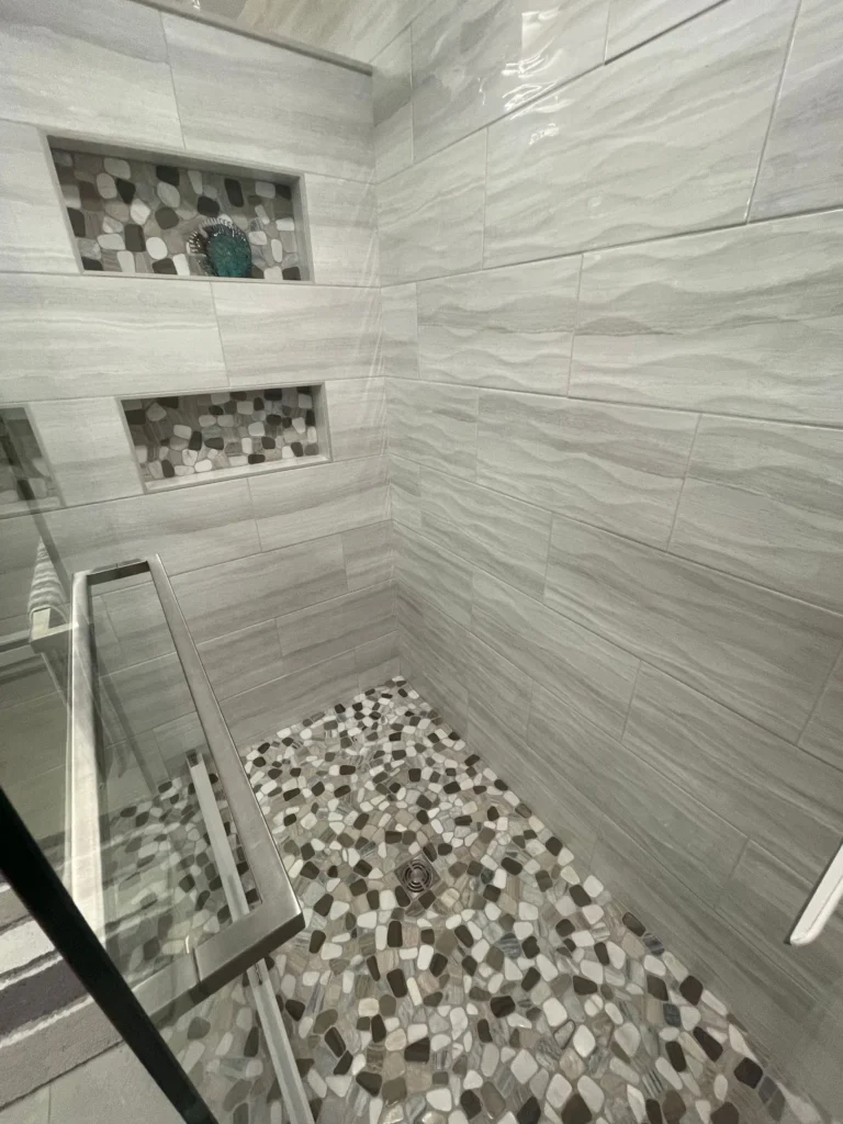Modern walk-in shower design with marble and hexagon tile in East Brunswick, NJ